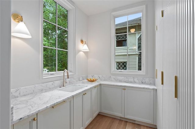 a spacious bathroom with a tub double sink window and mirror