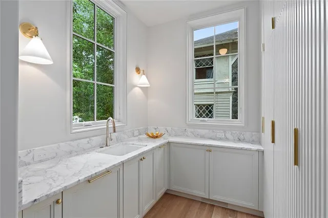 a spacious bathroom with a tub double sink window and mirror