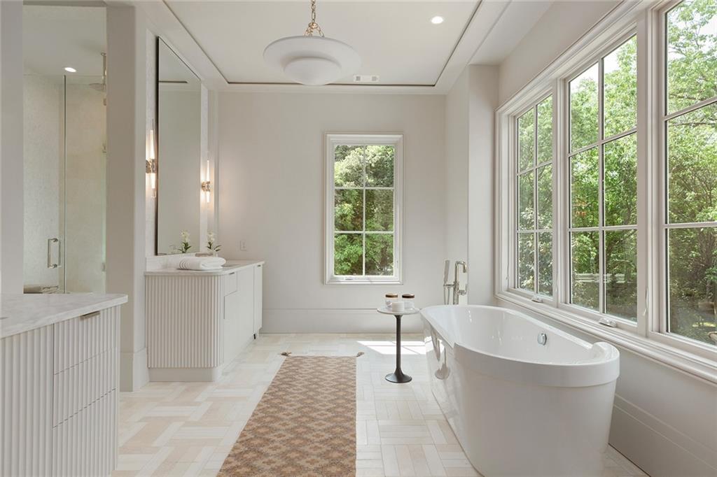 27 Maddox Drive Northeast Atlanta, GA 30309 - Photo 34 of 60 a spacious bathroom with a tub double sink window and mirror