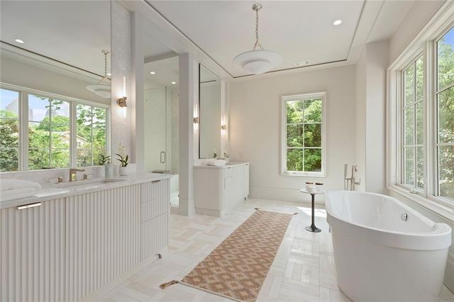 a bathroom with a granite countertop sink a toilet and a bathtub