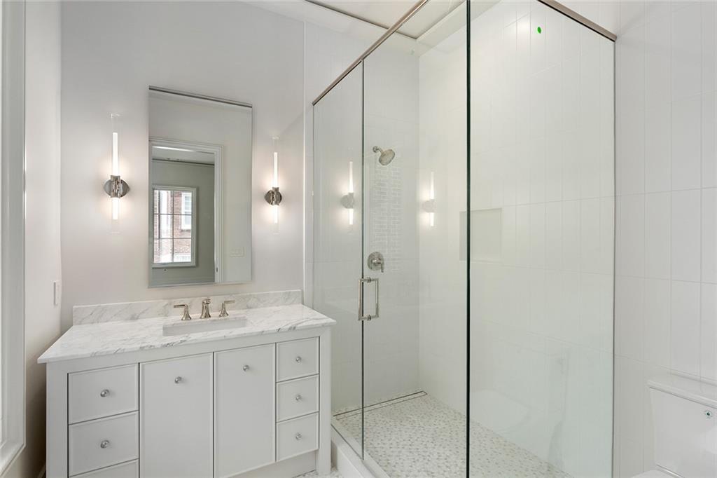 27 Maddox Drive Northeast Atlanta, GA 30309 - Photo 42 of 60 a bathroom with a shower sink and mirror