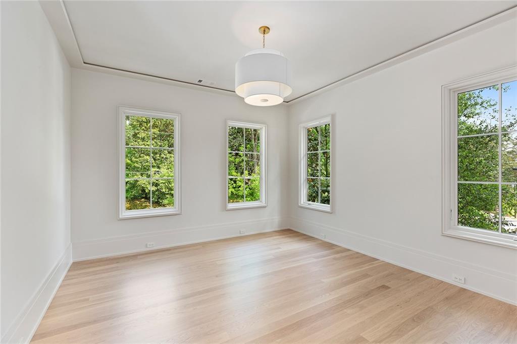 27 Maddox Drive Northeast Atlanta, GA 30309 - Photo 43 of 60 an empty room with wooden floor chandelier and windows