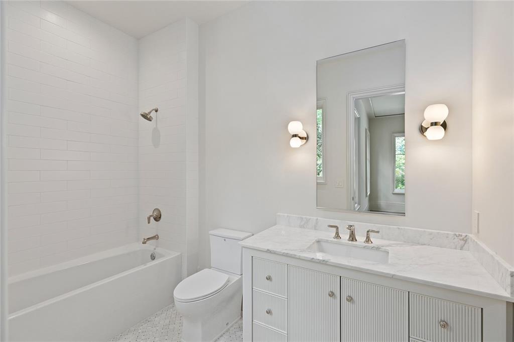 27 Maddox Drive Northeast Atlanta, GA 30309 - Photo 44 of 60 a bathroom with a granite countertop sink a toilet and a bathtub