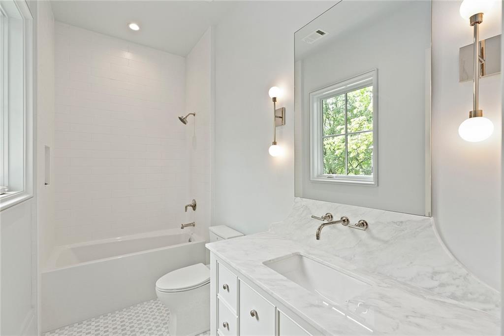 27 Maddox Drive Northeast Atlanta, GA 30309 - Photo 46 of 60 a bathroom with a granite countertop sink a toilet and bathtub