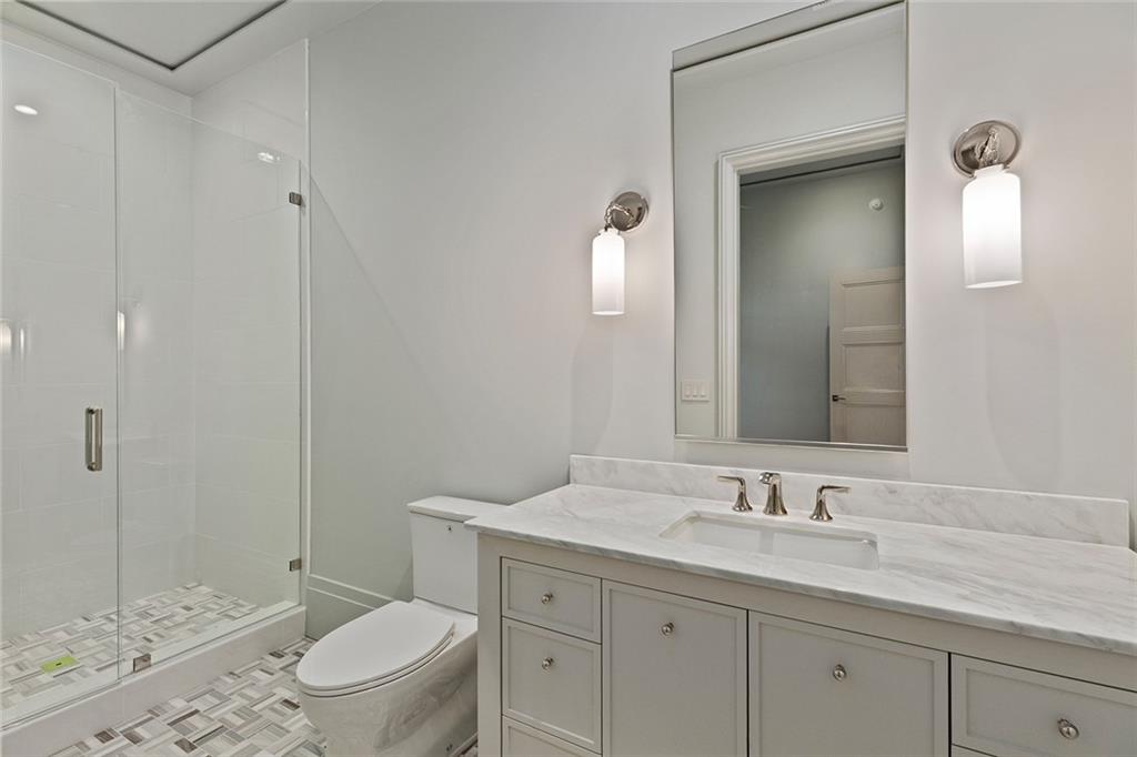 27 Maddox Drive Northeast Atlanta, GA 30309 - Photo 50 of 60 a bathroom with a granite countertop sink a toilet and a mirror