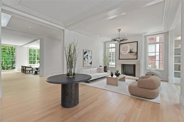 a living room with furniture a fireplace and a large window