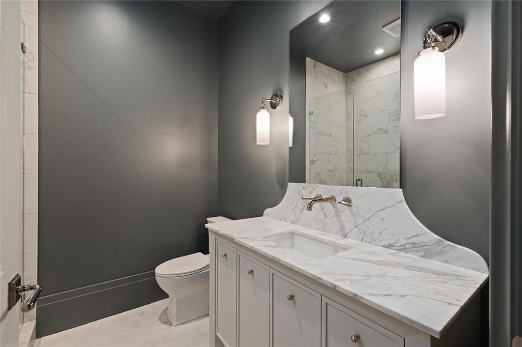 27 Maddox Drive Northeast Atlanta, GA 30309 - Photo 51 of 60 a bathroom with a granite countertop sink a toilet and shower