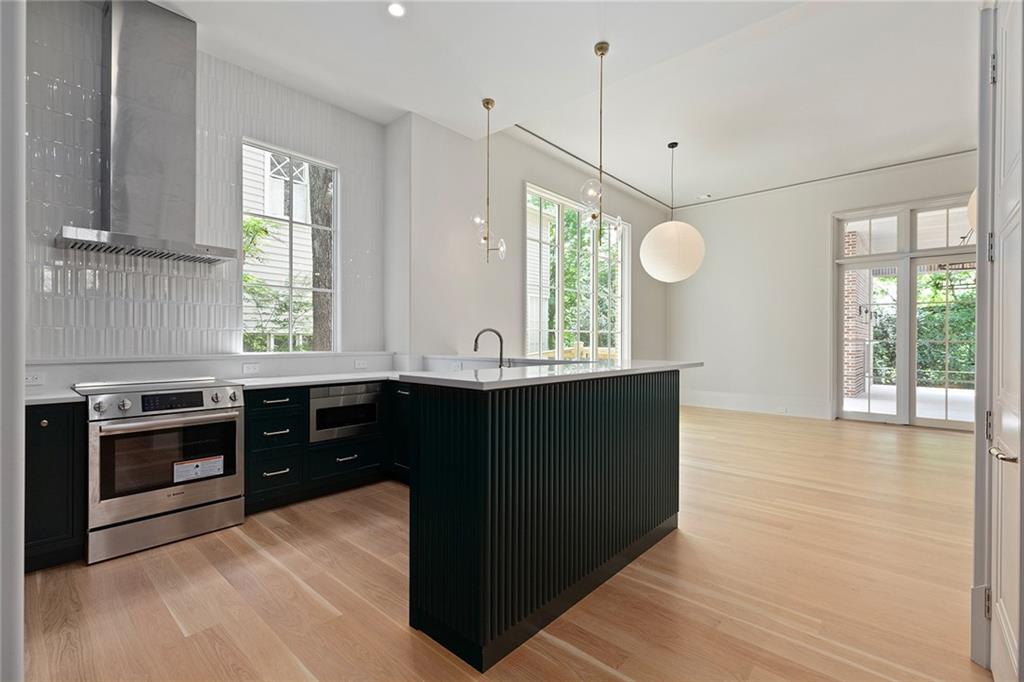 27 Maddox Drive Northeast Atlanta, GA 30309 - Photo 52 of 60 a kitchen with granite countertop a stove a sink and a window