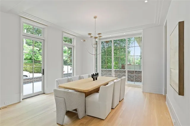 a living room with furniture chandelier and a fireplace
