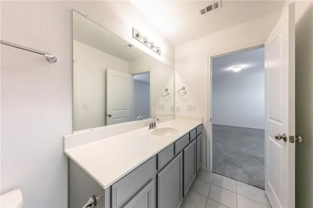a bathroom with a sink vanity and a mirror