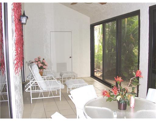 7727 La Mirada Drive, Unit 118 Boca Raton, FL 33433 - Photo 14 of 16 a dining room with furniture and flowers