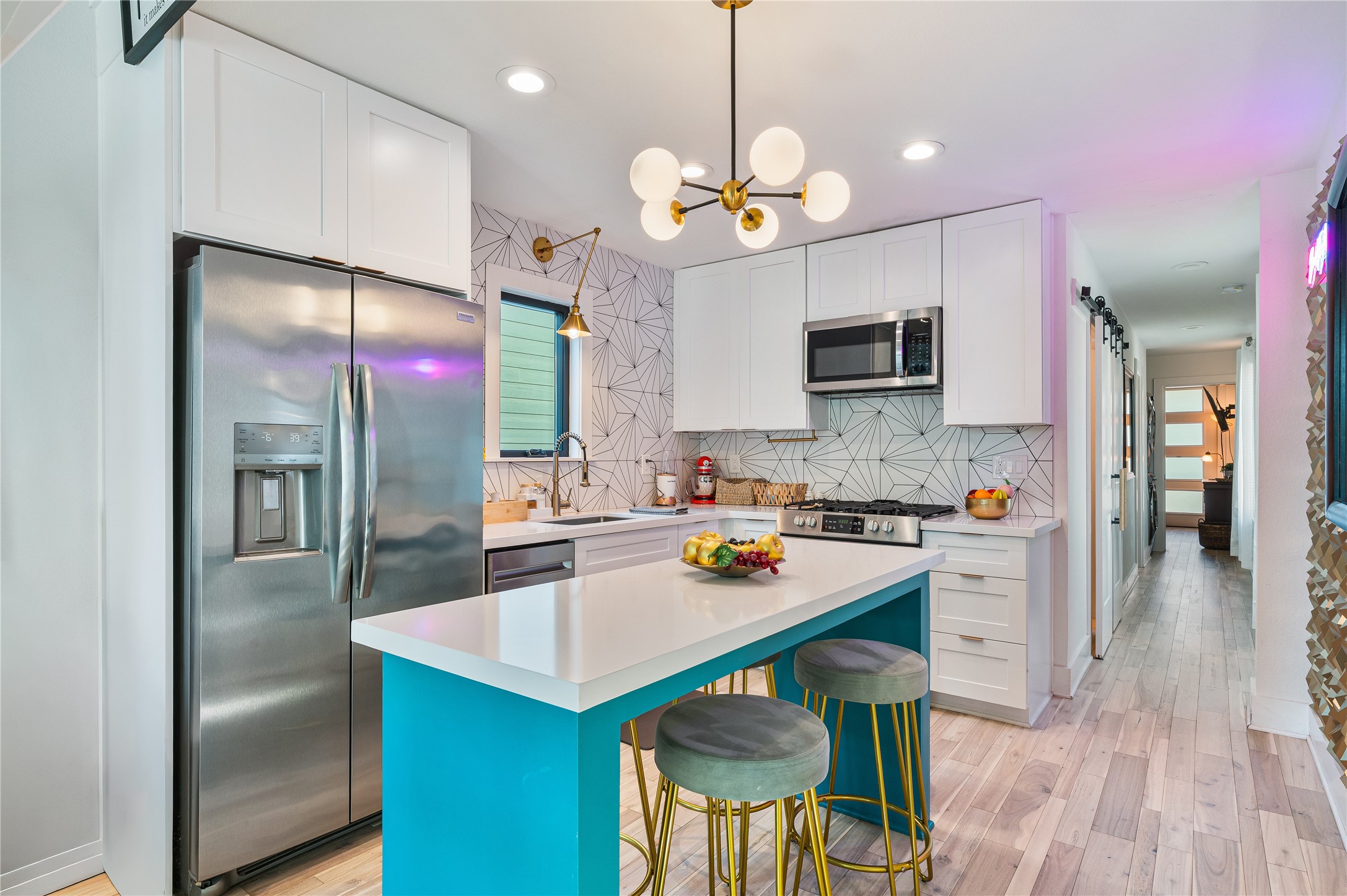 3817 Avenue R Galveston, TX 77550 - Photo 7 of 35 a kitchen with a center island and stainless steel appliances