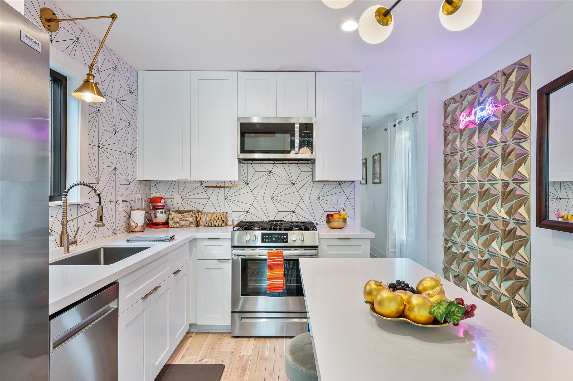 3817 Avenue R Galveston, TX 77550 - Photo 8 of 35 a kitchen with stainless steel appliances a sink cabinets and wooden floor