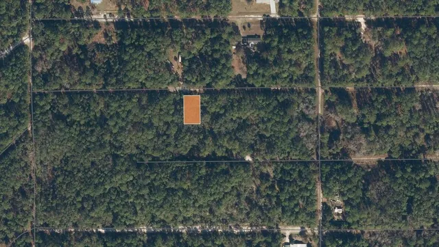 a aerial view of a house with a yard