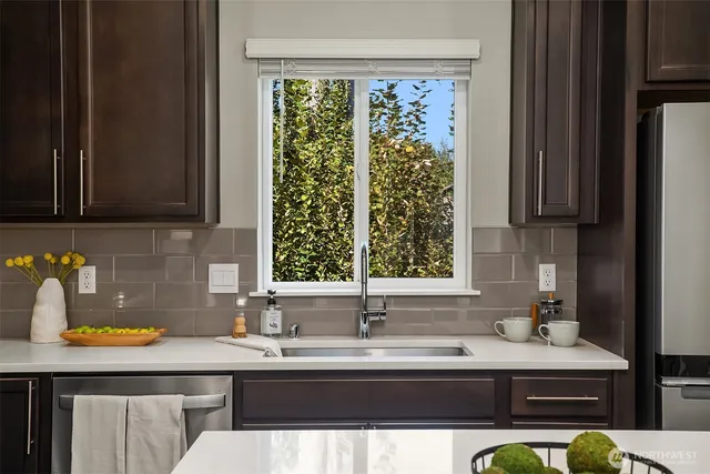 a kitchen with a sink window and cabinets