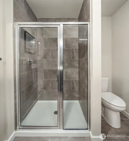 a bathroom with a shower and toilet
