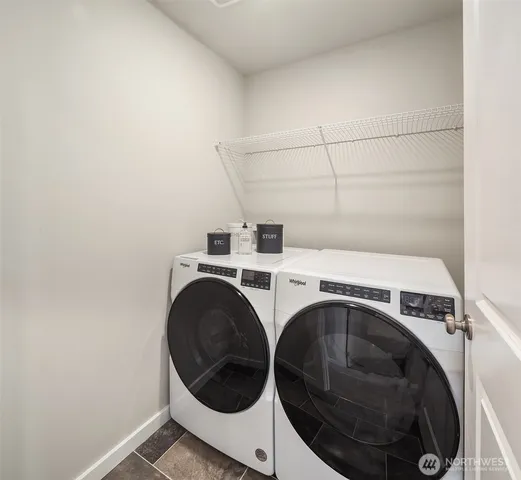 a bedroom with a bed and painting on the wall