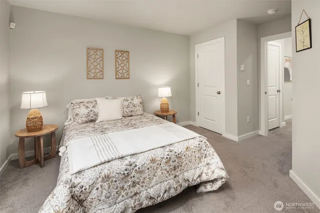 a bedroom with a bed and a potted plant
