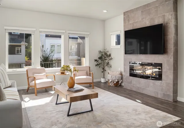 a living room with furniture a flat screen tv and a fireplace