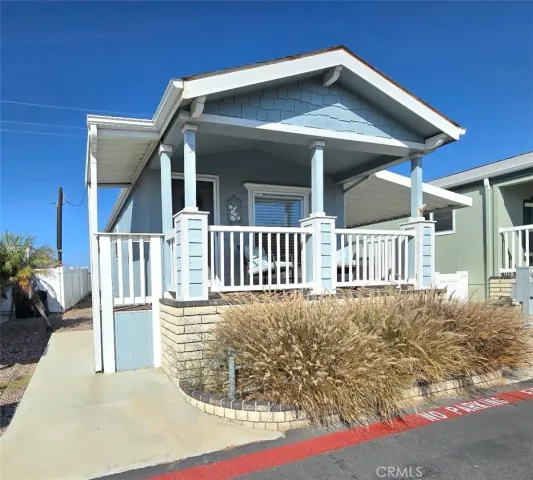 a view of a house with wooden deck front of house