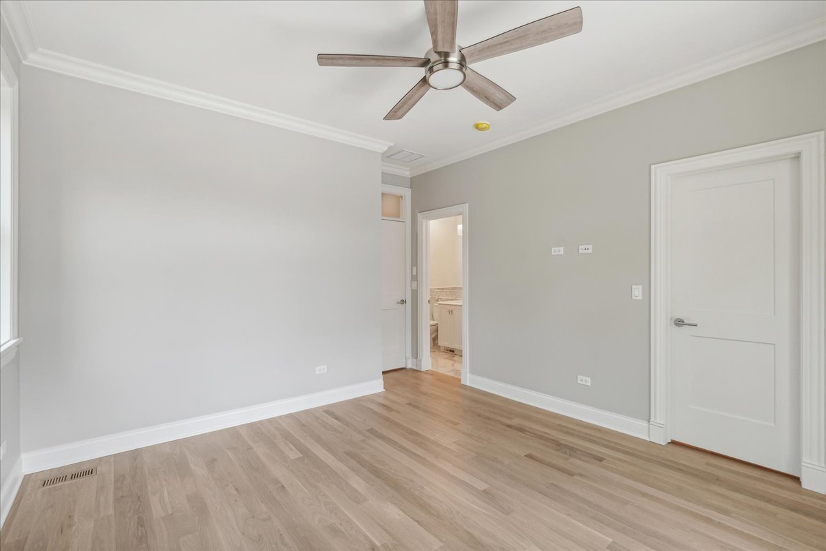1457 West Roscoe Street, Unit 2 Chicago, IL 60657 - Photo 14 of 16 wooden floor in an empty room