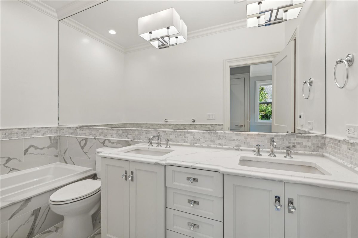 1457 West Roscoe Street, Unit 2 Chicago, IL 60657 - Photo 15 of 16 a bathroom with a sink vanity granite and toilet