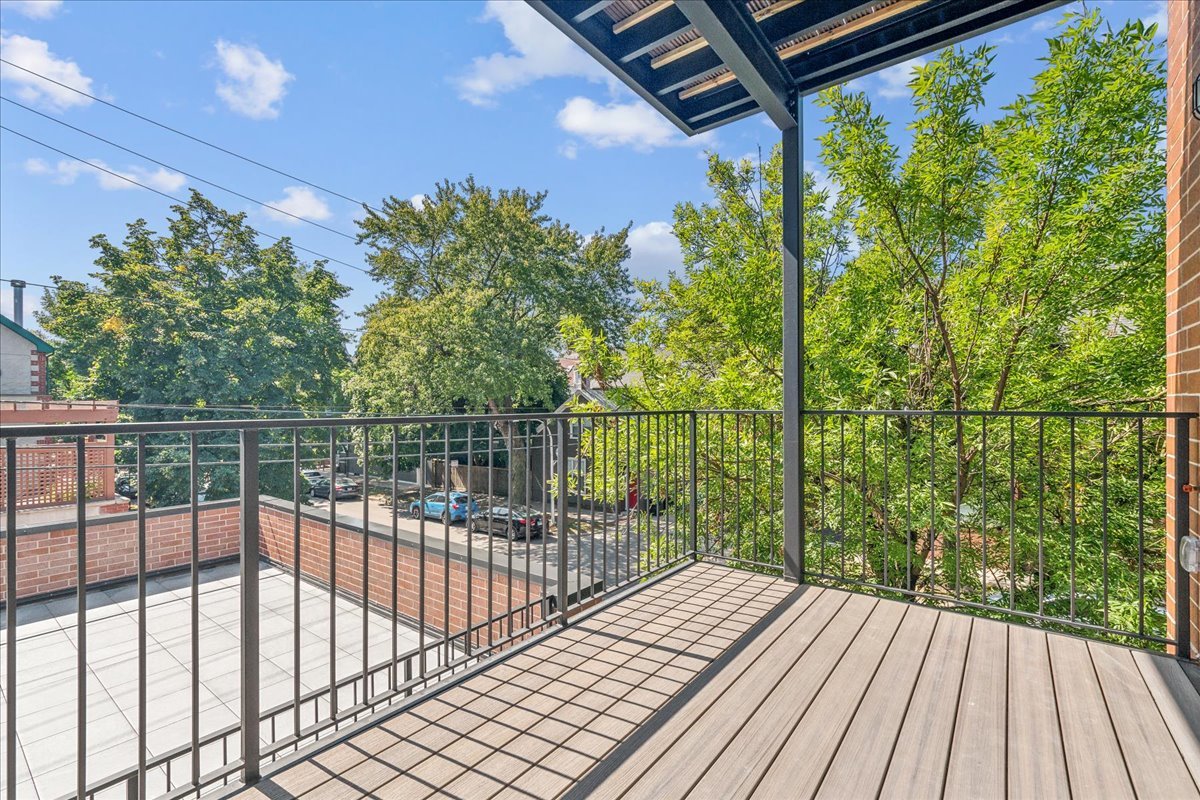 1457 West Roscoe Street, Unit 2 Chicago, IL 60657 - Photo 16 of 16 a view of a balcony with wooden floor
