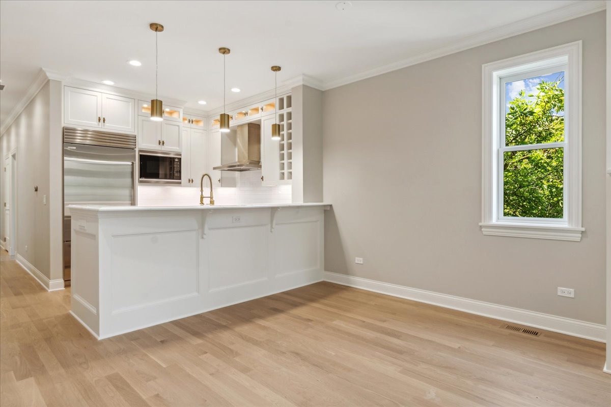 1457 West Roscoe Street, Unit 2 Chicago, IL 60657 - Photo 5 of 16 a view of a kitchen with a sink and a window