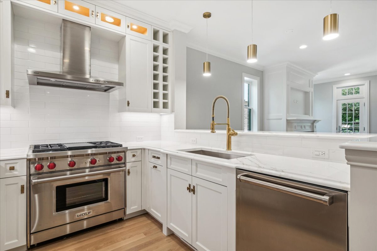 1457 West Roscoe Street, Unit 2 Chicago, IL 60657 - Photo 7 of 16 a kitchen with stainless steel appliances granite countertop a stove and a sink