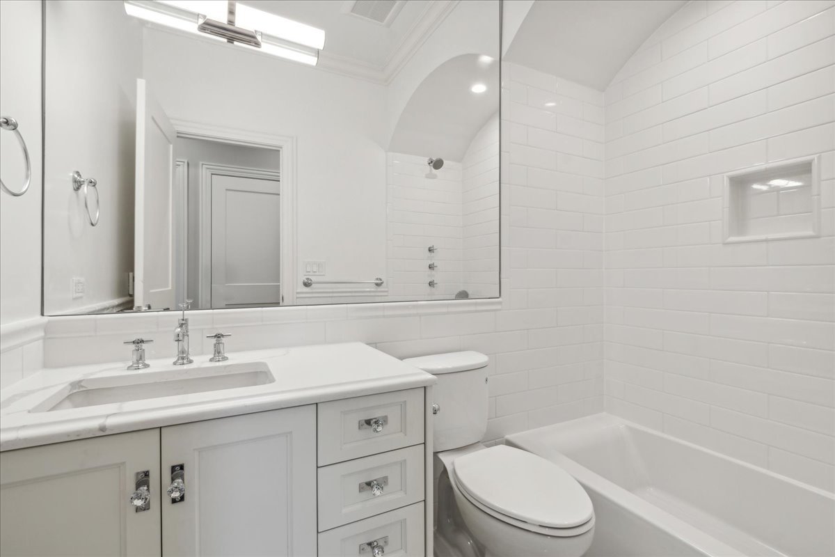 1457 West Roscoe Street, Unit 2 Chicago, IL 60657 - Photo 10 of 16 a bathroom with a sink a toilet and shower