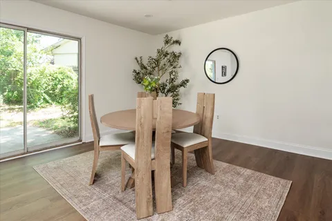 a view of a dining room with furniture window and wooden floor