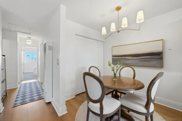 a dining room with furniture and wooden floor