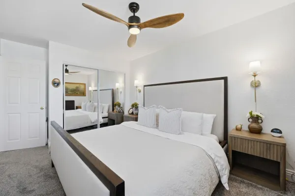 a bedroom with a bed and ceiling fan