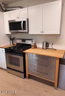 512 West 17th Street Tempe, AZ 85281 - Photo 7 of 13 a kitchen with stainless steel appliances a stove a microwave a sink and cabinets