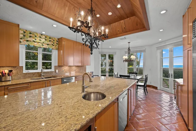 a kitchen with center island table and chairs in it