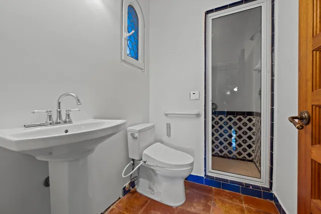 a bathroom with a sink toilet and shower