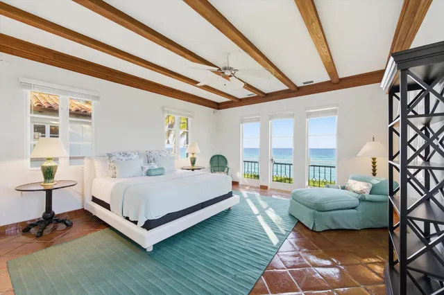 a bedroom with a bed and a large window with outer view