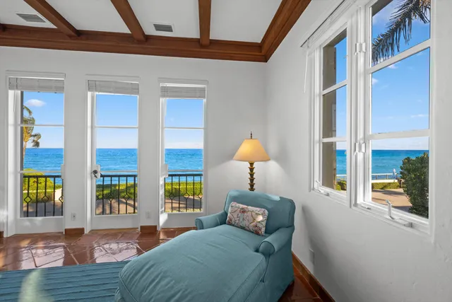 a bedroom with a bed wooden floor and window