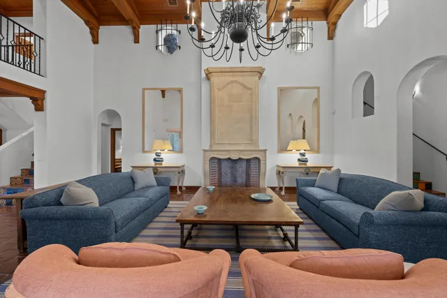 a living room with furniture a rug and a chandelier