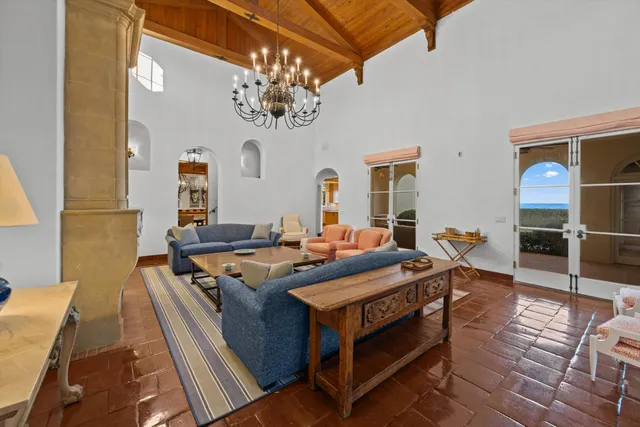 a view of a dining room with furniture a chandelier and wooden floor
