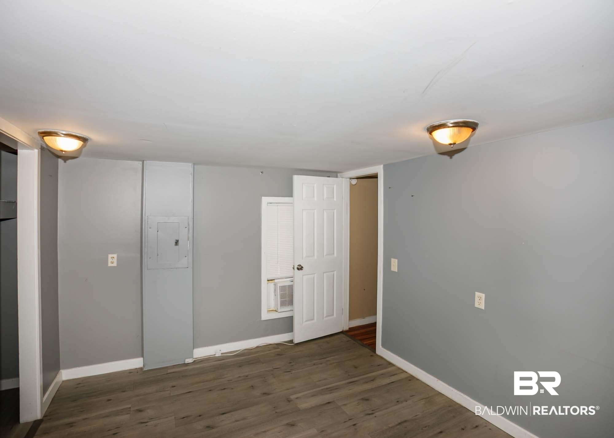 11998 Workman Avenue Foley, AL 36535 - Photo 47 of 59 Unfurnished bedroom with electric panel and wood finished floors