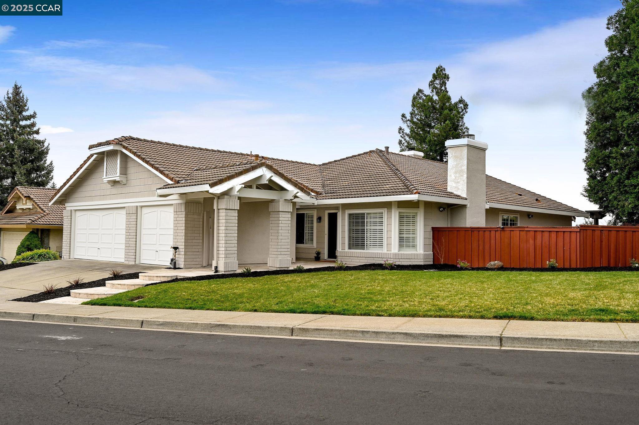 5095 Canyon Crest Drive San Ramon, CA 94582 - Photo 1 of 1 a front view of a house with a yard and garage