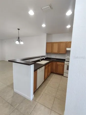 a kitchen with stainless steel appliances granite countertop a sink and cabinets