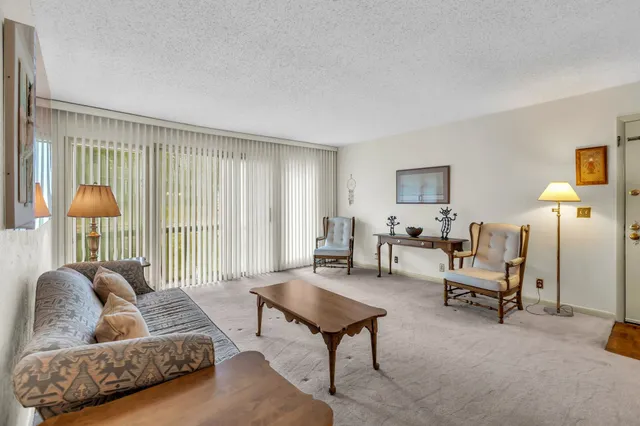 a living room with furniture and a lamp