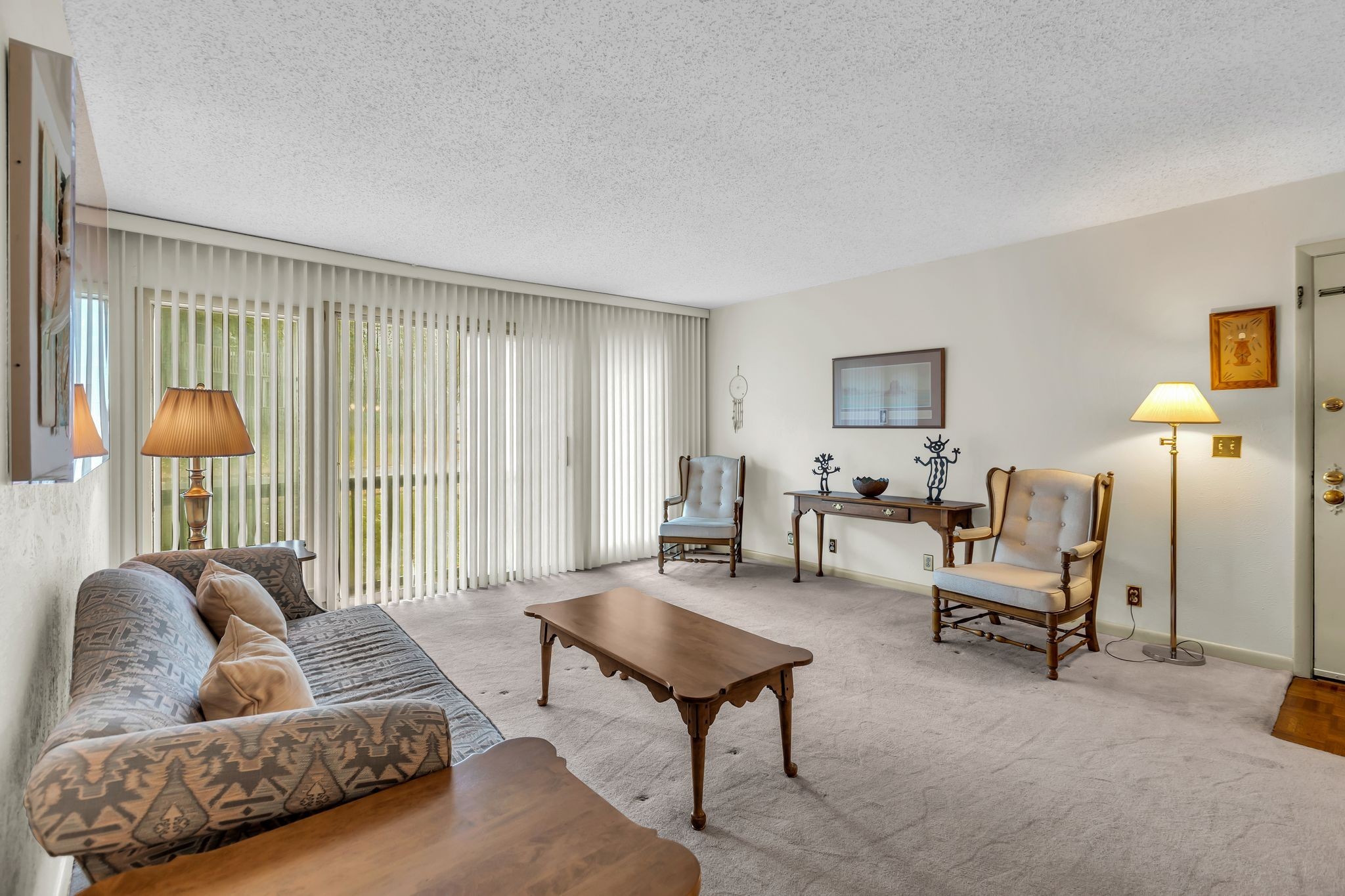 a living room with furniture and a lamp