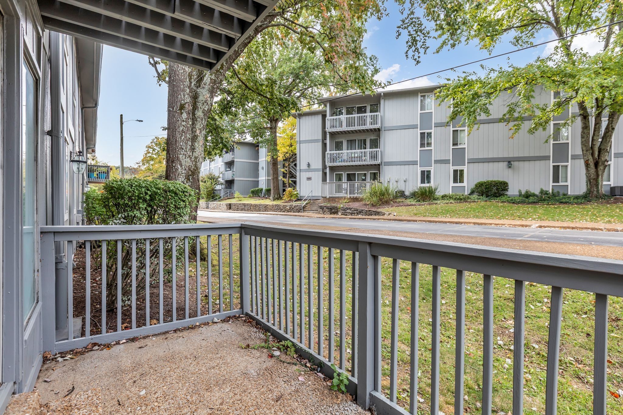 21 Vaughns Gap Road, Unit A22 Nashville, TN 37205 - Photo 26 of 28 a balcony view with a large window and wooden fence