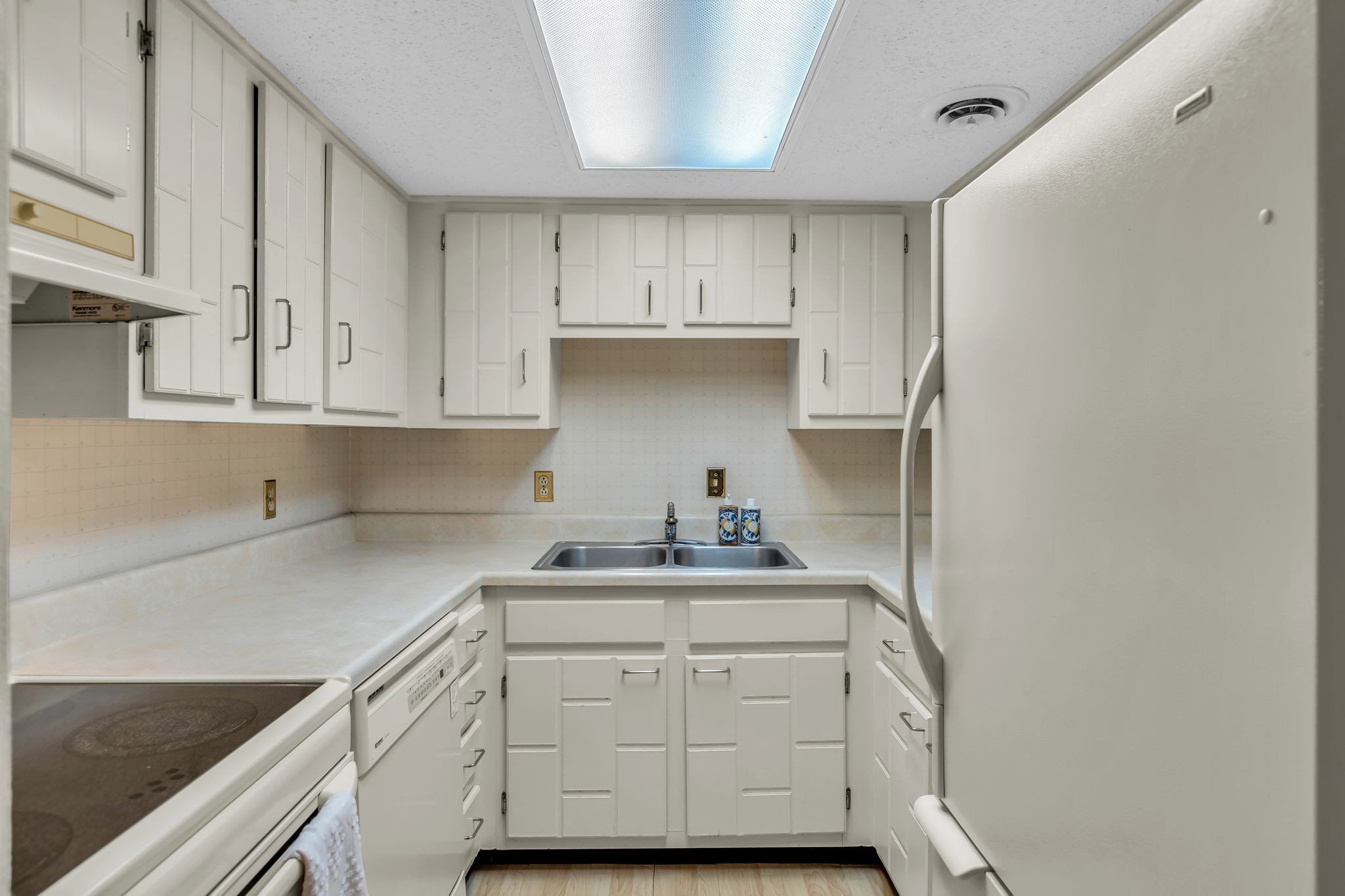 21 Vaughns Gap Road, Unit A22 Nashville, TN 37205 - Photo 7 of 28 a kitchen with a sink a stove and cabinets