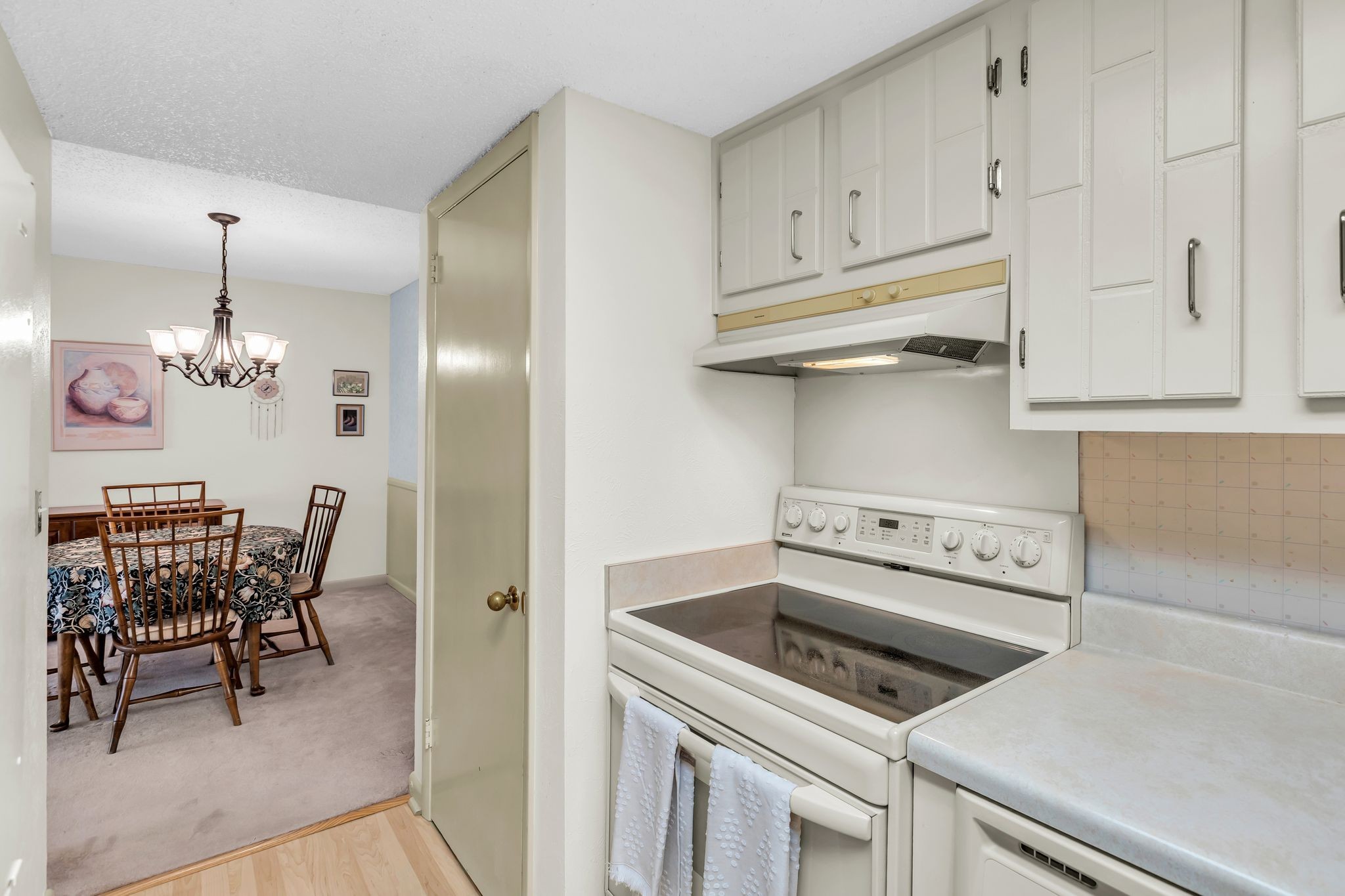 21 Vaughns Gap Road, Unit A22 Nashville, TN 37205 - Photo 9 of 28 a kitchen with a stove two chairs and a refrigerator