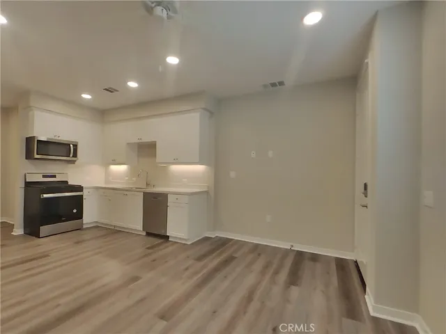 a view of a kitchen with a sink and a stove top oven