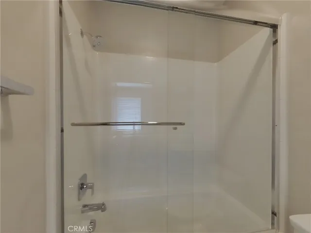 a bathroom with a glass shower door